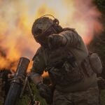 A Ukrainian soldier gestures as he fires toward Russian position on the frontline in Zaporizhzhia region, Ukraine, Saturday, June 24, 2023.