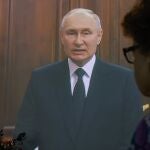 una mujer escucha el discurso a la nación de Vladimir Putin del pasado sábado