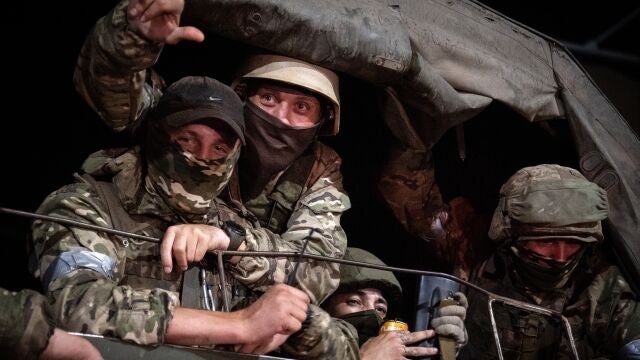 Members of Wagner group looks from a military vehicle in Rostov-on-Don late on June 24, 2023. - Rebel mercenary leader Yevgeny Prigozhin who sent his fighters to topple the military leaders in Moscow will leave for Belarus and a criminal case against him will be dropped as part of a deal to avoid "bloodshed," the Kremlin said on June 24. 