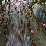 Runners stream into the bullring in this photo taken with a slow camera shutter speed during the running of the bulls at the San Fermin Festival in Pamplona, northern Spain.