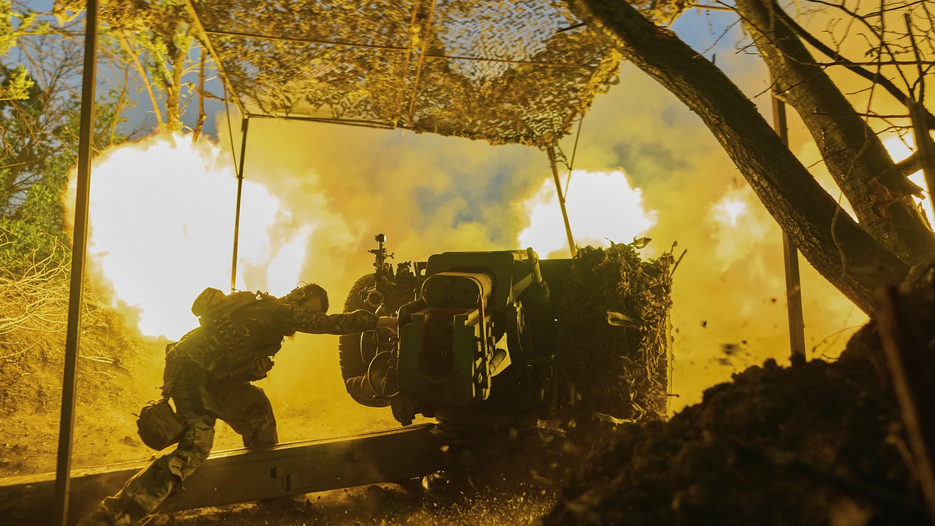 A Ukrainian serviceman of the 10th Assault Brigade Edelweiss fires a D-30 cannon towards Russian positions at the front line, near Bakhmut, Donetsk region, Ukraine.
