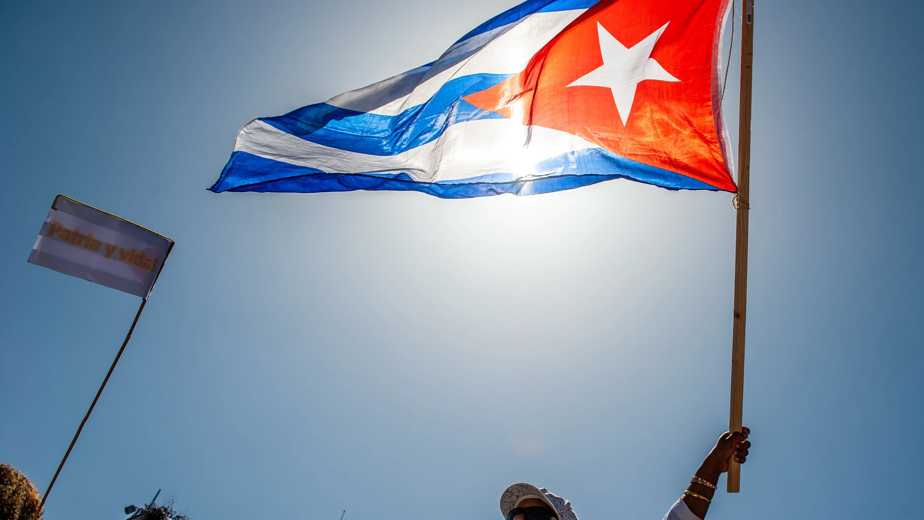 July 17, 2021, Amsterdam, North Holland, Netherlands: A protester holds a Cuban flag during the demonstration..Cuban people living in The Netherlands organized a pacific protest at the Dam square in the center of Amsterdam, in support of anti-government protests in Cuba. Cuban citizens have taken to the streets across the country for the first time in more than six decades to protest against deteriorating living conditions and the lack of basic goods and services, including medical attention ...