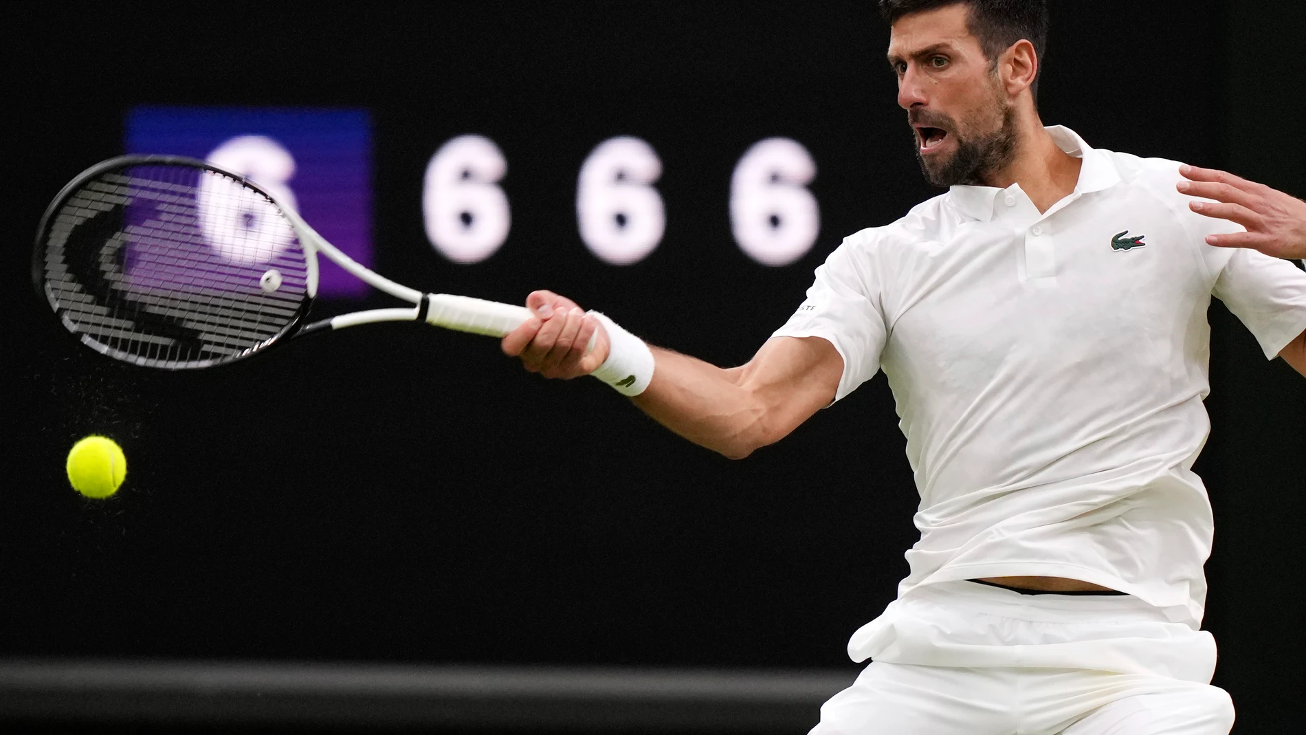 Serbia's Novak Djokovic in action against Italy's Jannik Sinner during their men's singles semifinal match on day twelve of the Wimbledon tennis championships in London, Friday, July 14, 2023. (AP Photo/Alberto Pezzali)