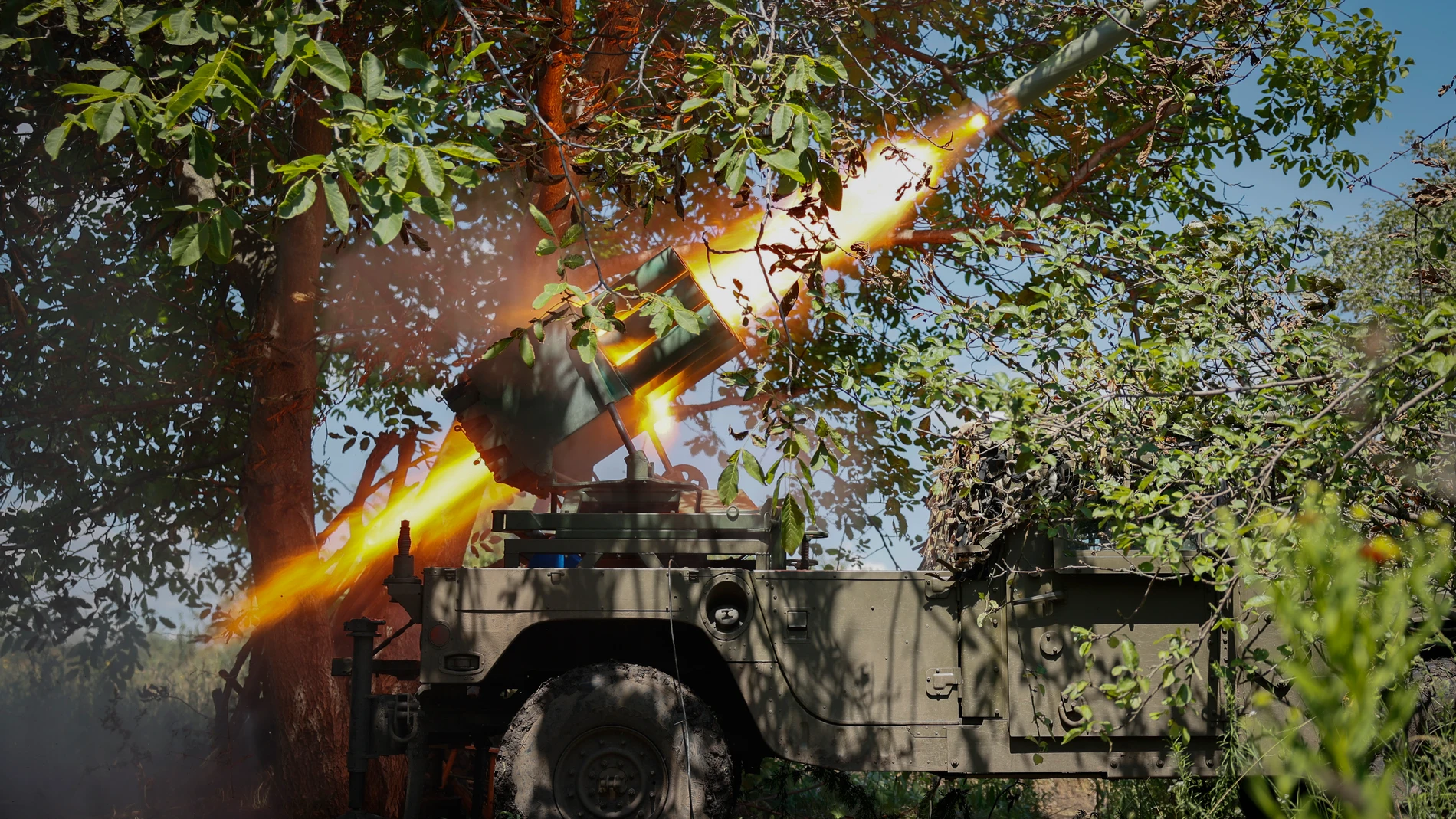 FILE - Ukrainian soldiers fire a Croatian RAK-SA-12 128mm multiple rocket launcher towards the Russian positions on the frontline near Bakhmut in the Donetsk region, Ukraine, Monday, July 10, 2023. Ukrainian forces are making steady progress along the northern and southern flanks of Bakhmut, in a semi-encirclement of the wrecked city that Russian forces have been occupying since May. (Roman Chop via AP, File)