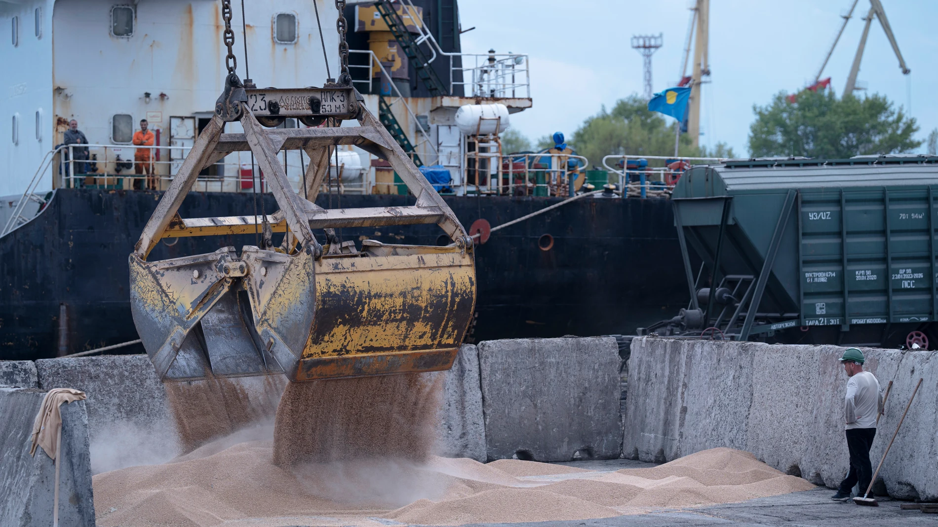 FILE - Workers load grain at a grain port in Izmail, Ukraine, on April 26, 2023. The fate of a wartime deal designed to move food from Ukraine to parts of the world where millions are going hungry is unclear as it faces renewal Monday July 17, 2023. (AP Photo/Andrew Kravchenko, File)