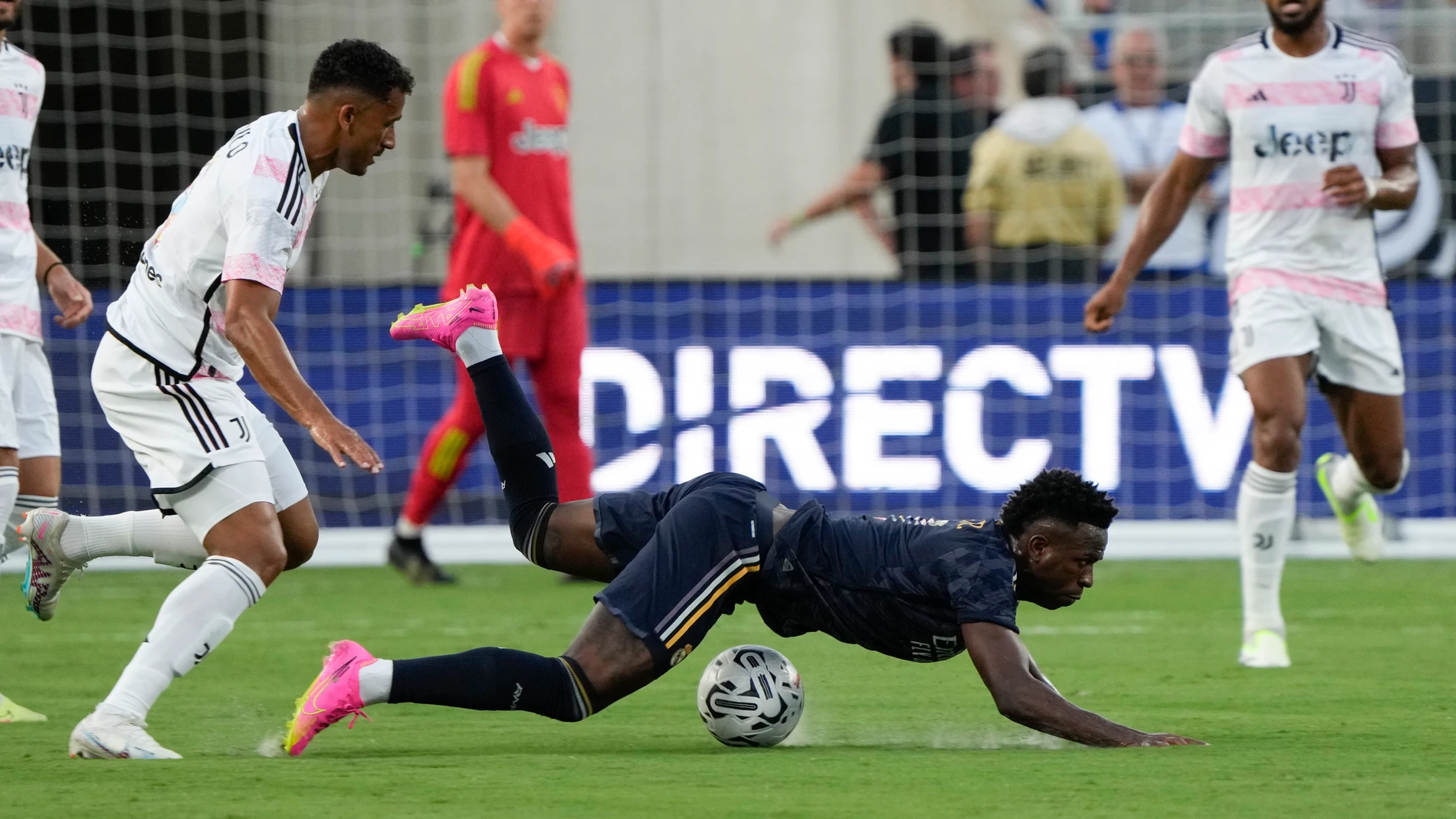 Juventus defender Danilo, left, trips up Real Madrid forward Vinicius Jose Paixao while trying to get position on the ball during the first half of a Champions Cup soccer match, Wednesday, Aug. 2, 2023, in Orlando, Fla. (AP Photo/John Raoux)