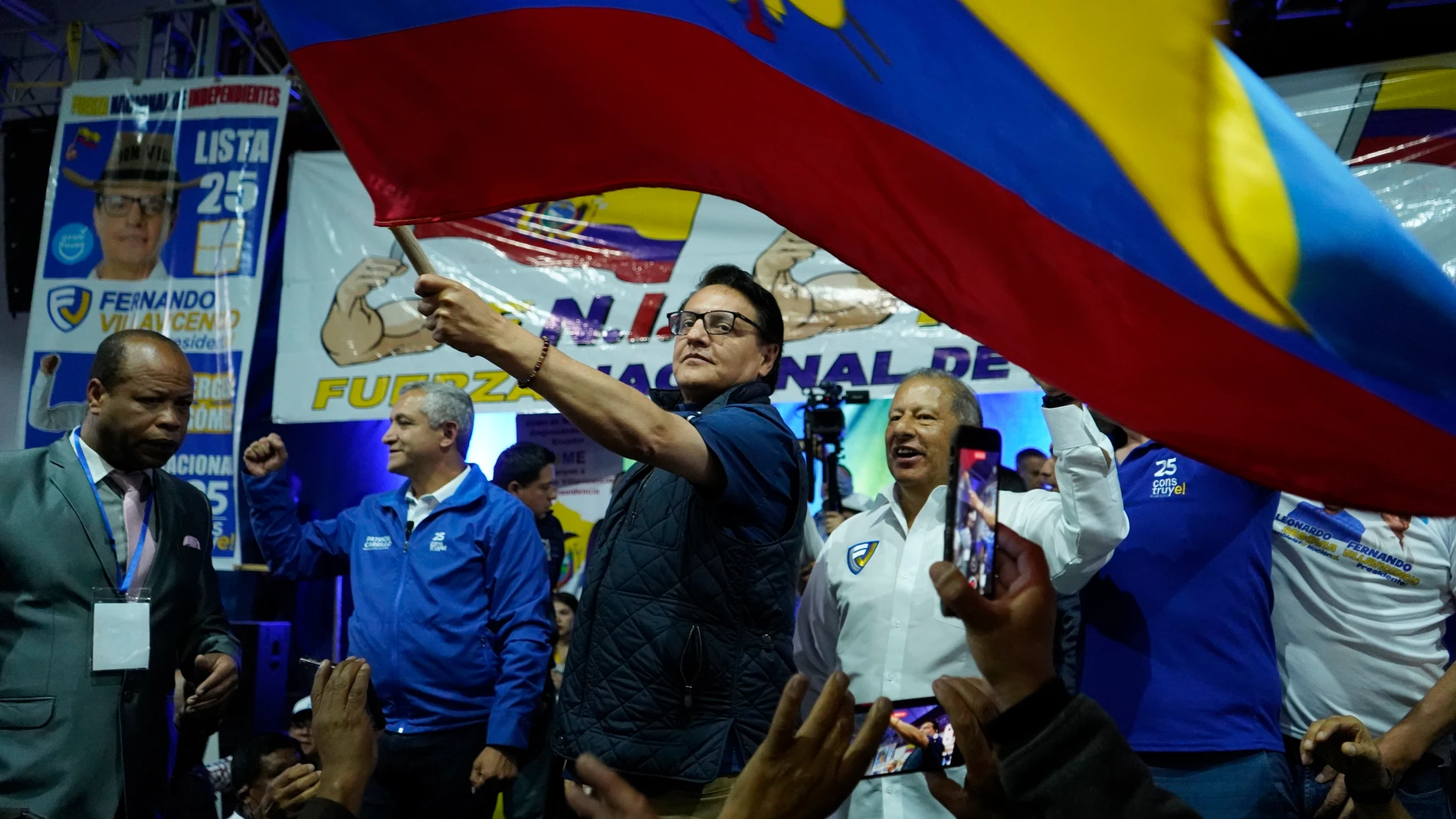 Presidential candidate Fernando Villavicencio waves an Ecuador national flag during a campaign event at a school minutes before he was shot to death outside the same school in Quito, Ecuador, Wednesday, Aug. 9, 2023 (API via AP)