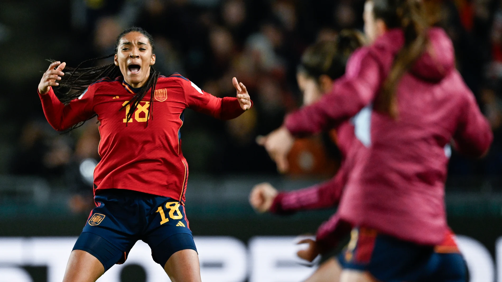 Spain's Salma Paralluelo celebrates as her teammates run onto the pitch after defeating Sweden in the Women's World Cup semifinal soccer match at Eden Park in Auckland, New Zealand, Tuesday, Aug. 15, 2023. (AP Photo/Andrew Cornaga)