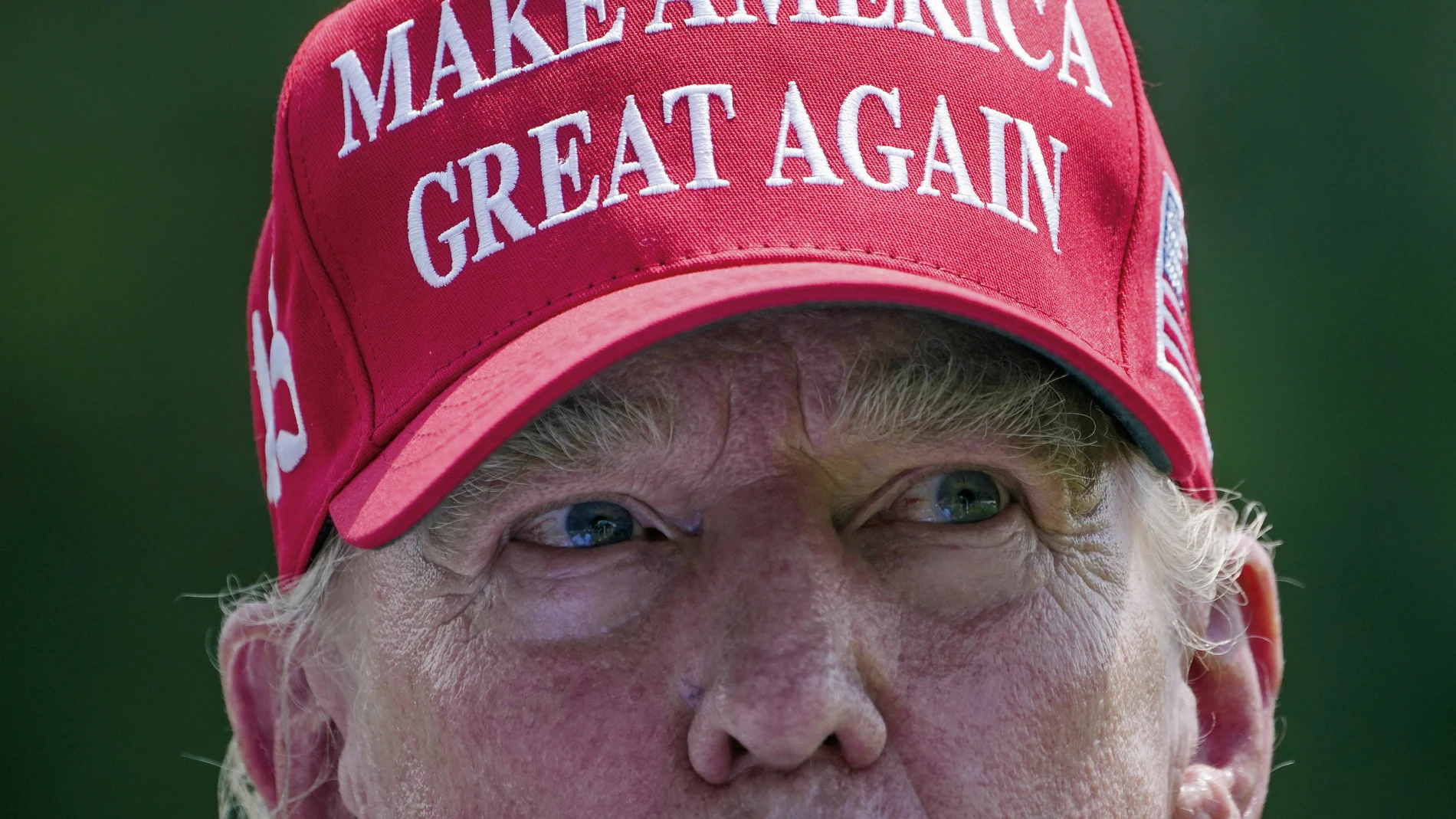 Former President Donald Trump greets golfers and supporters on the driving range before the start of the final round of the Bedminster Invitational LIV Golf tournament in Bedminster