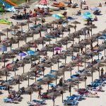 Sombrillas para protegerse del sol en la playa de Cala en Porter, Menorca.