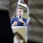  French President Emmanuel Macron (C) addresses employees of the 'lycee professionnel de l'Argensol' or Argensol vocational school, during his visit to the school in Orange, Southeastern France.