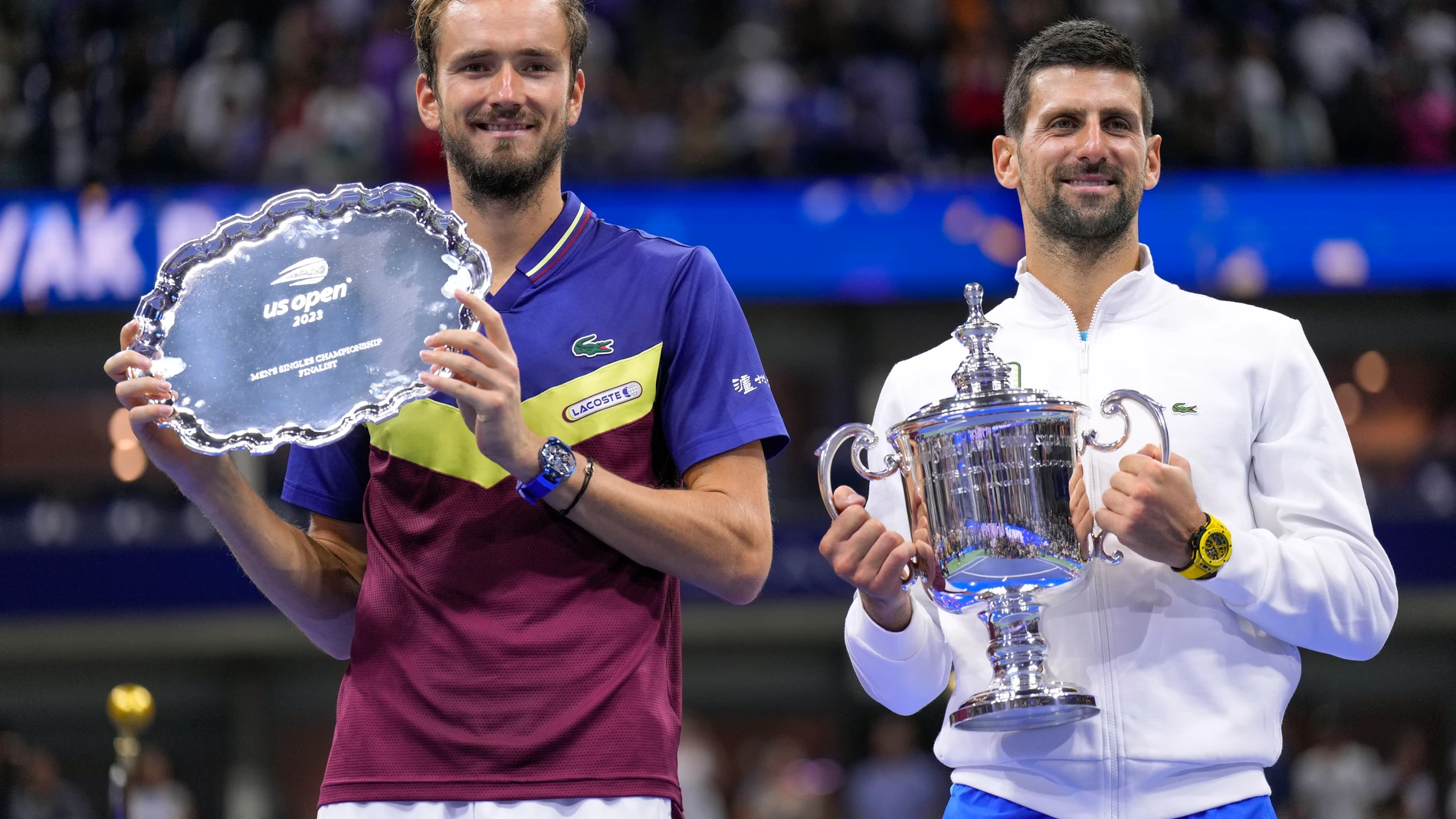Daniil Medvedev, of Russia, left, holds up the runner-up trophy as Novak Djokovic, of Serbia, holds up the championship trophy after the men's singles final of the U.S. Open tennis championships, Sunday, Sept. 10, 2023, in New York. (AP Photo/Manu Fernandez)