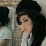 In this Feb. 16, 2007 file photo, British singer Amy Winehouse poses for photographs after being interviewed by The Associated Press at a studio in north London.