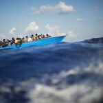 FILE - Migrants sail a wooden boat at south of the Italian Lampedusa island at the Mediterranean sea, Aug. 11, 2022. The back-to-back shipwrecks of migrant boats off Greece that left at least 22 people dead this week has once again put the spotlight on the dangers of the Mediterranean migration route to Europe. (AP Photo/Francisco Seco, file)