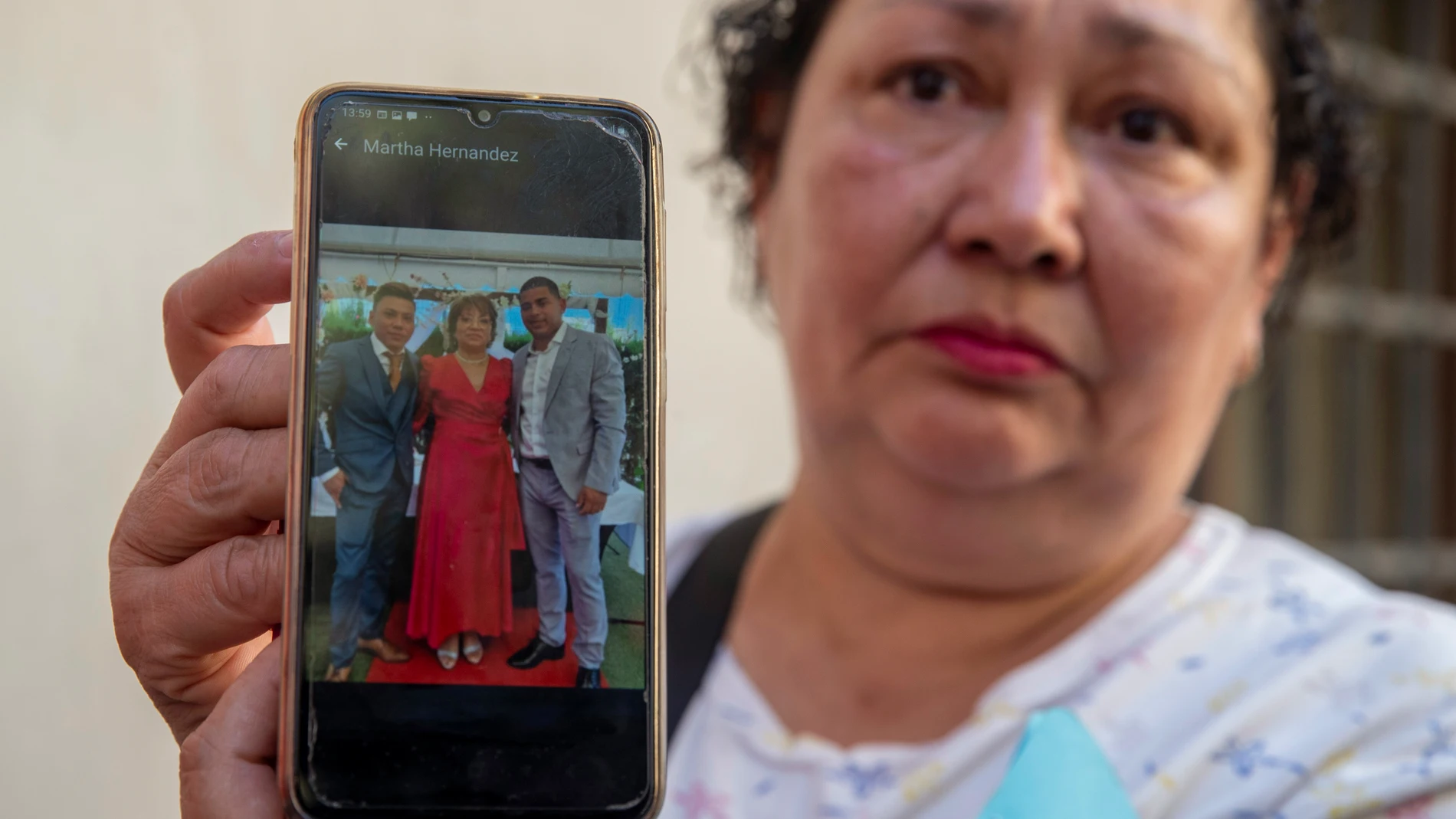 MURCIA, 02/10/2023.- Miriam Montealegre, muestra una foto de sus sobrinos, Erick Torres (d), el chico que celebraba su cumpleaños en la discoteca Fonda Milagros de Murcia de su hermano Sergio Silva (i) y la madre Martha Hernánez (c), los tres desaparecidos en el incendio este lunes, en la Jefatura Superior de la Policía Nacional, en Murcia. Familiares de los fallecidos en el incendio que en la madrugada del domingo arrasó dos discotecas en Murcia se han acercado esta mañana a la sede de la Je...