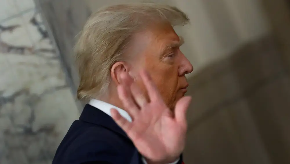 Former US President Donald J. Trump gestures to the media during a short recess on the third day of his civil fraud trial in New York.