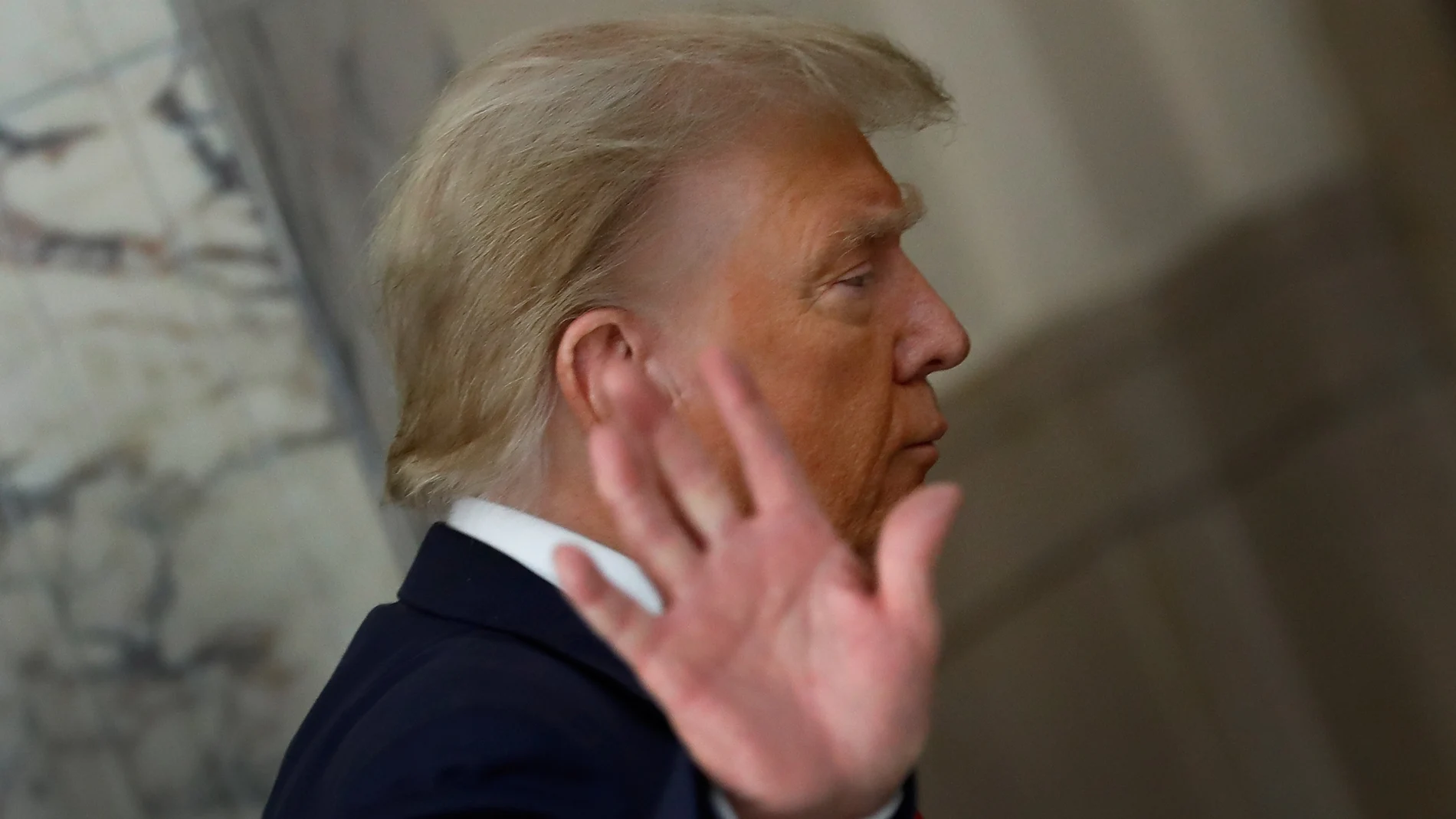Former US President Donald J. Trump gestures to the media during a short recess on the third day of his civil fraud trial in New York.
