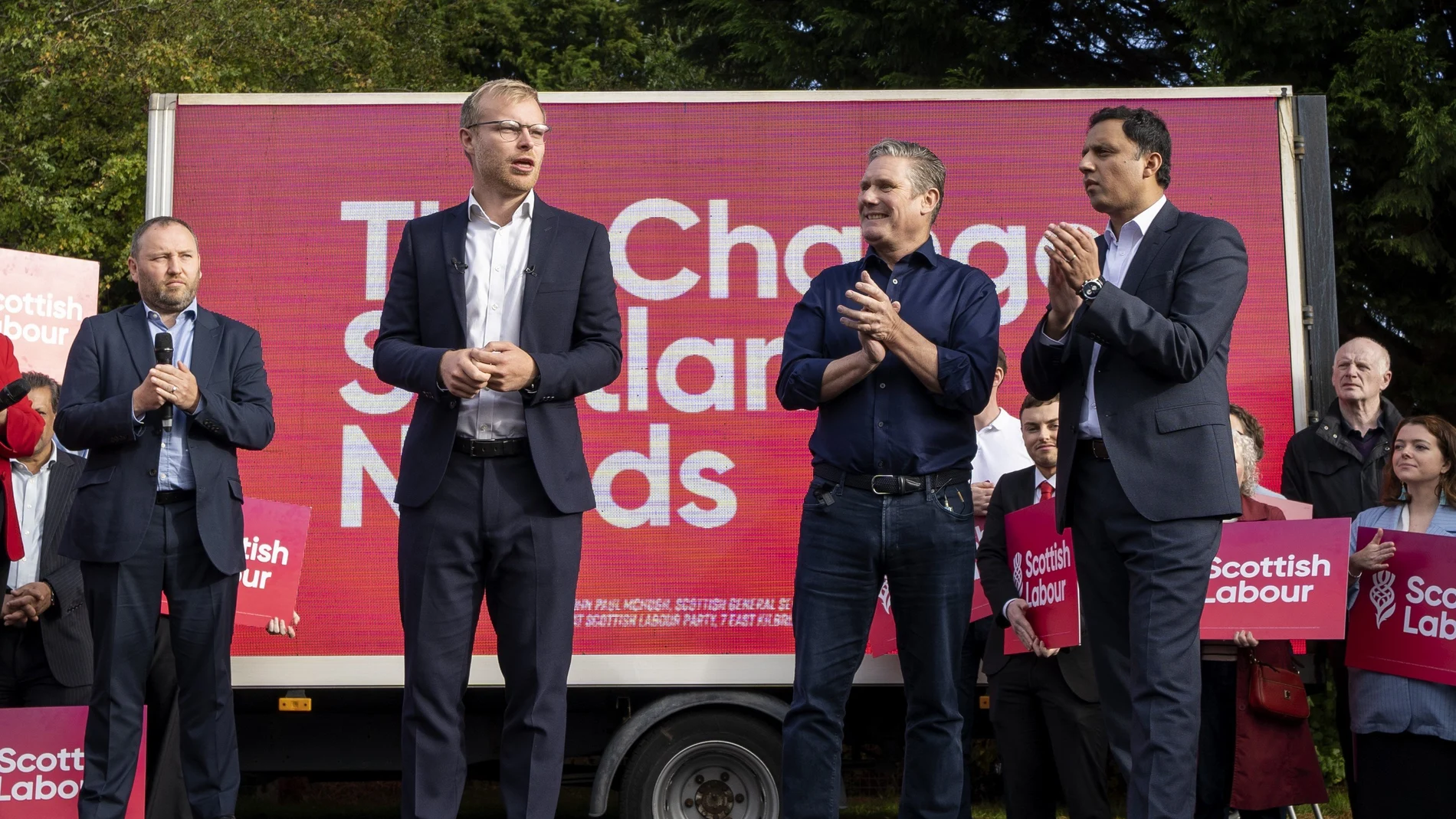 UK's Labour leader Sir Keir Starmer (C) with Scottish Labour leader Anas Sarwar (R) and the new Labour MP for Rutherglen and Hamilton West Michael Shanks (L) at a rally following Scottish Labour's win in Rutherglen and Hamilton West by-election.