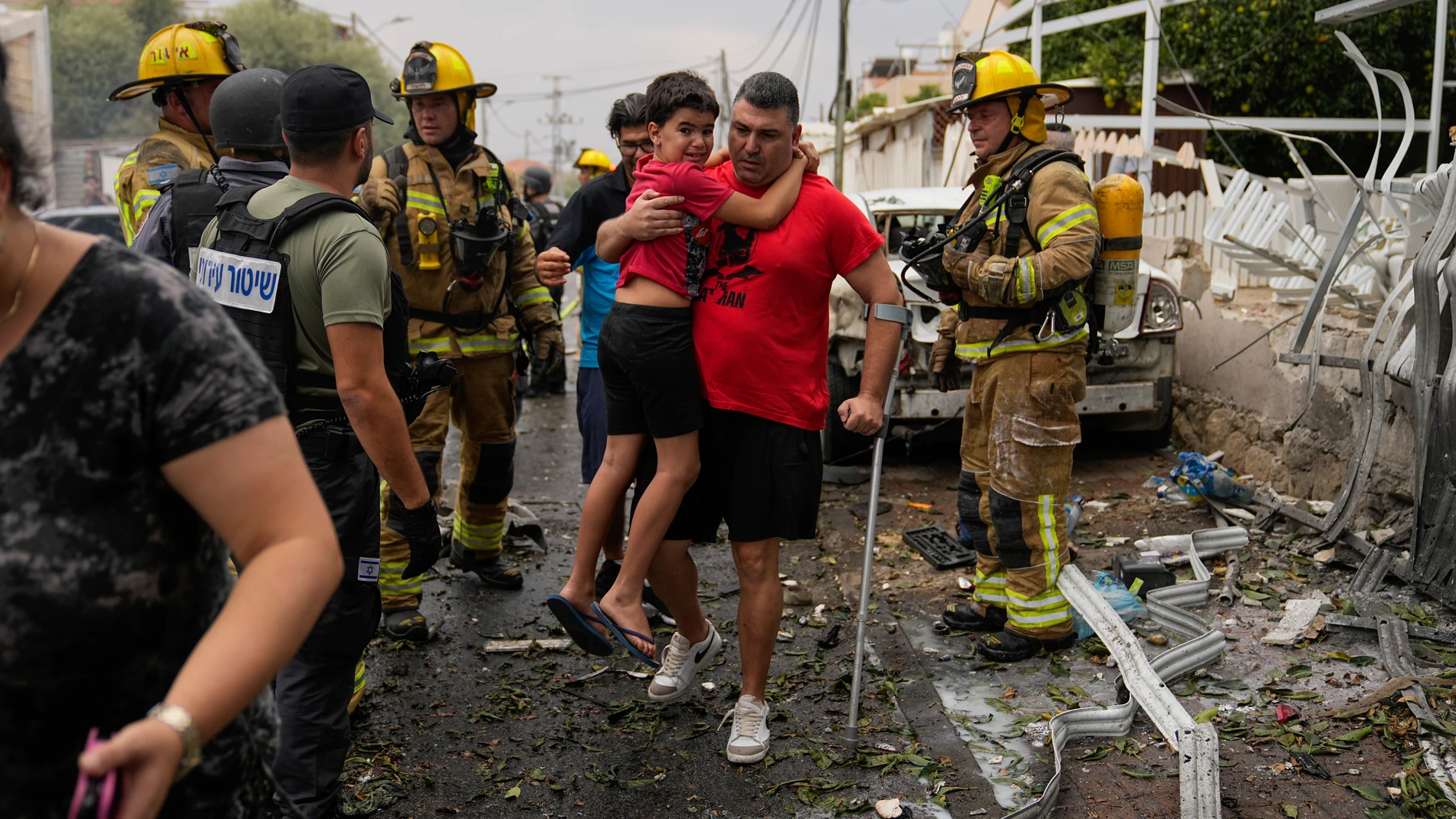 Israelis evacuate a site struck by a rocked fired from the Gaza Strip, in Ashkelon, southern Israel, Monday, Oct. 9, 2023. (AP Photo/Ohad Zwigenberg)