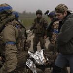 Ukrainian servicemen evacuate injured comrade at the frontline close to the Dnipro near Kherson, Ukraine, Saturday, Oct. 14, 2023. 