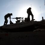  Israeli soldiers on their Merkava tank during maneuvers at an undisclosed location along the border with Lebanon, in Israel, 26 October 2023. 