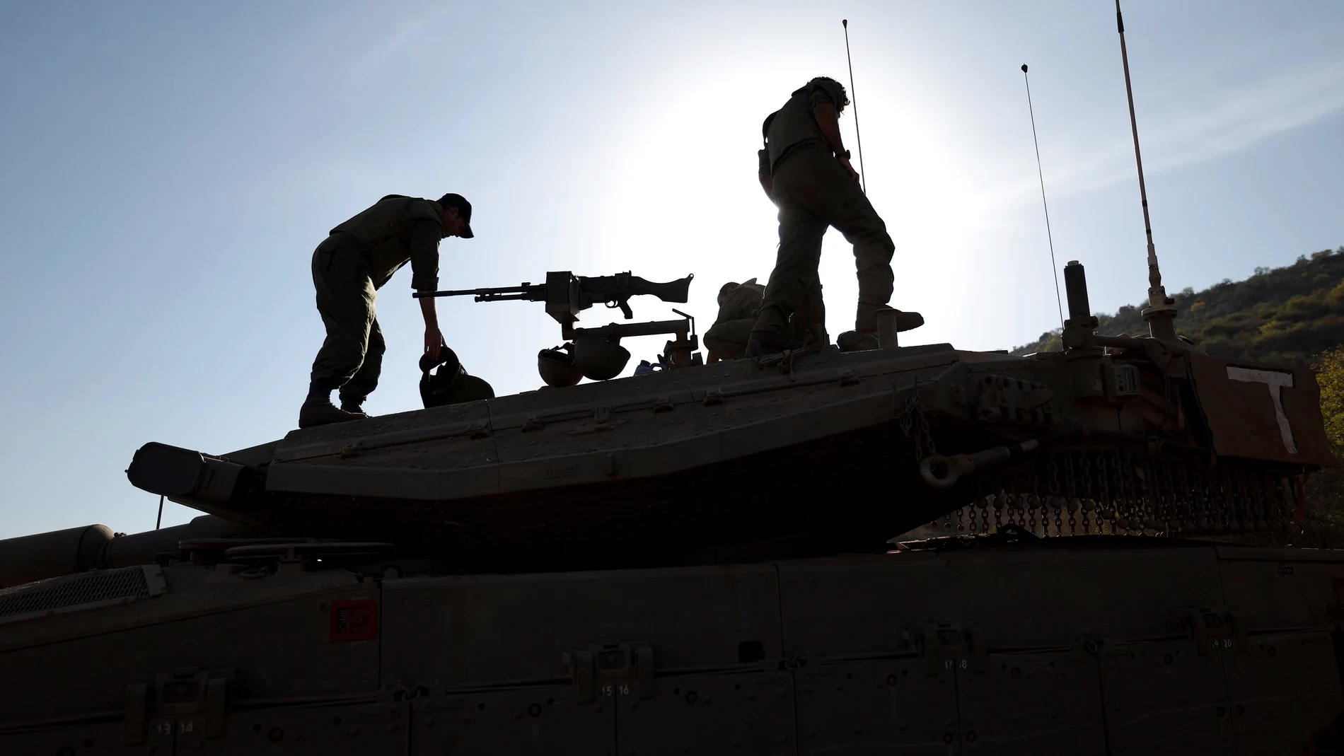 Israeli soldiers on their Merkava tank during maneuvers at an undisclosed location along the border with Lebanon, in Israel, 26 October 2023.
