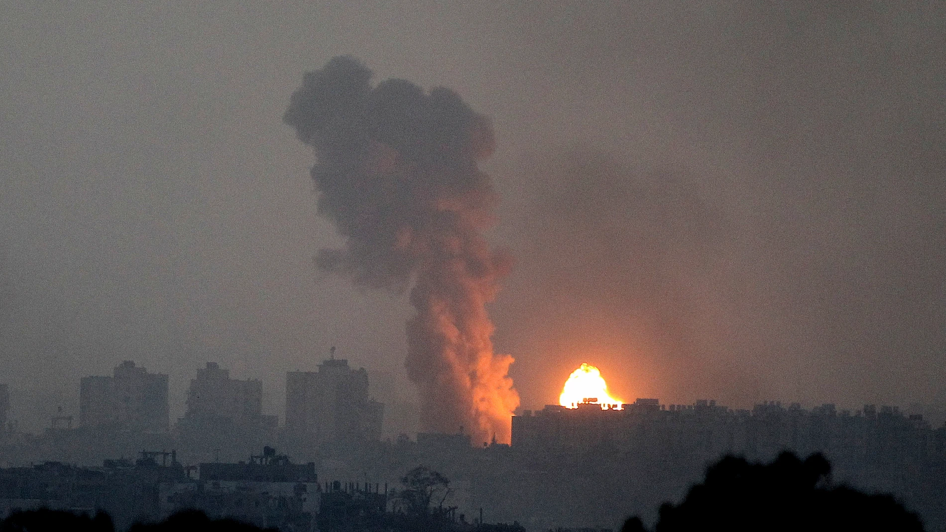Fire and smoke rise following an Israeli airstrike in the Gaza Strip, as seen from southern Israel, Saturday, Oct. 28, 2023. (AP Photo/Ilan Assayag)