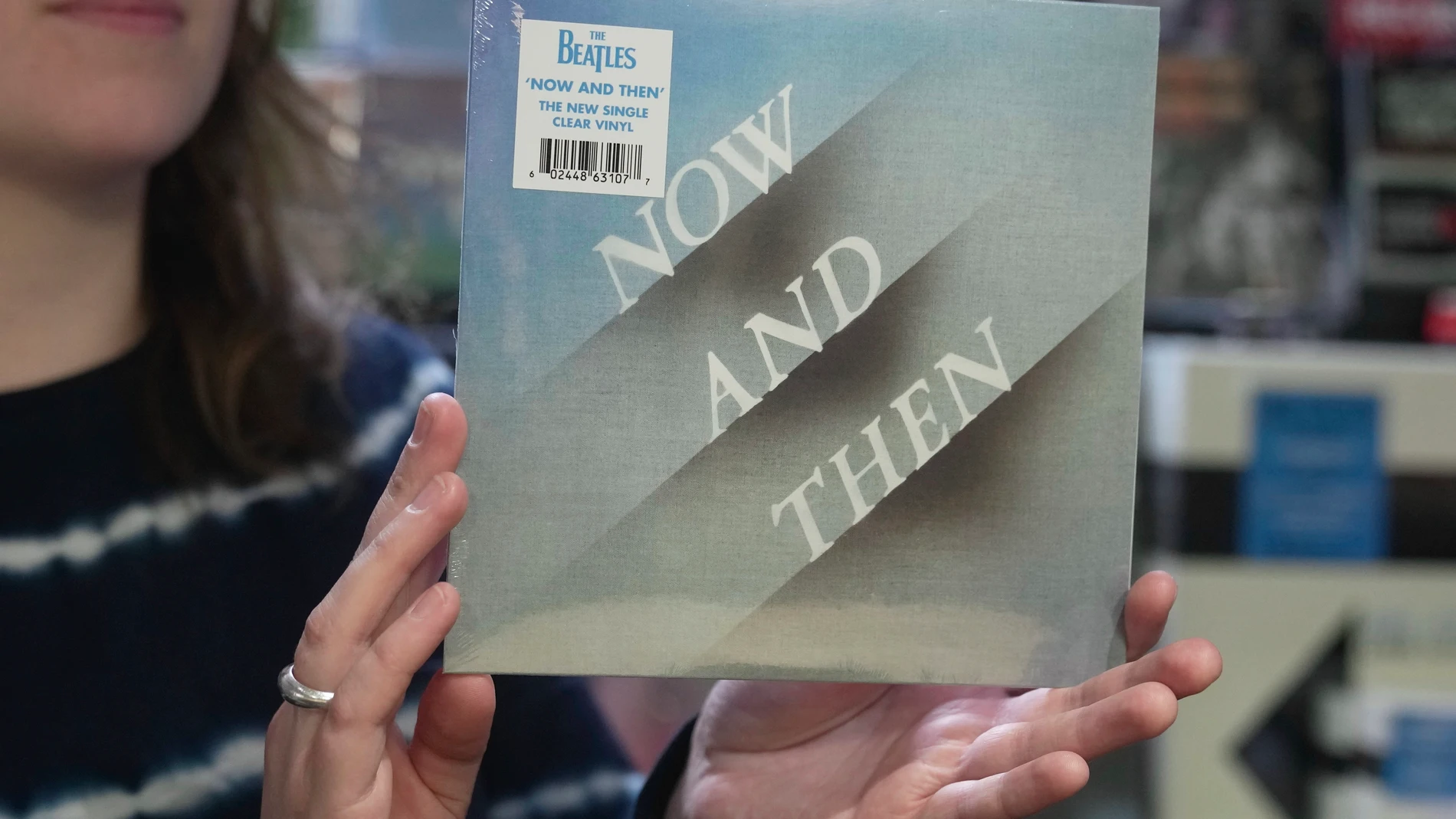 A staff member from a record store holds a new Beatles single titled "Now and Then," which is on sale in London, Friday, Nov. 3, 2023. More than four decades since Lennon's murder and two since George Harrison's death, the very last Beatles song has been released as a double A-side single with "Love Me Do," the band's 1962 debut single. Titled "Now and Then," the almost impossible-to-believe track is four minutes and eight seconds of the first and only original Beatles recording of the 21st c...