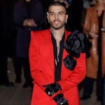 Rauw Alejandro con traje rojo y maxi flores.
