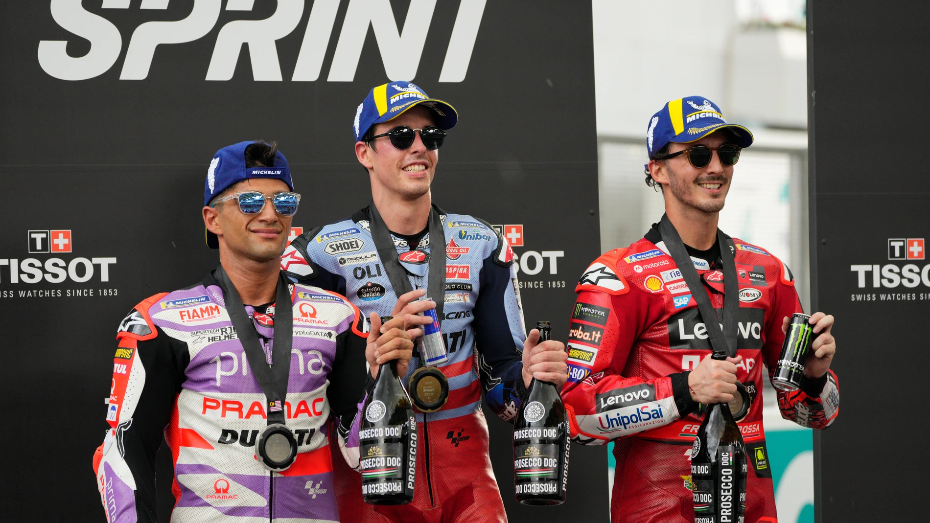 Gresini Racing MotoGP's Spanish rider Alex Marquez, center, poses with second place Prima Pramac's Spanish rider Jorge Martin, left, and third placed Ducati Lenovo Team's Italian rider Francesco Bagnaia after the sprint race during the MotoGP Malaysian Grand Prix at the Sepang International Circuit in Sepang, Malaysia Saturday, Nov. 11, 2023. (AP Photo/Vincent Thian)