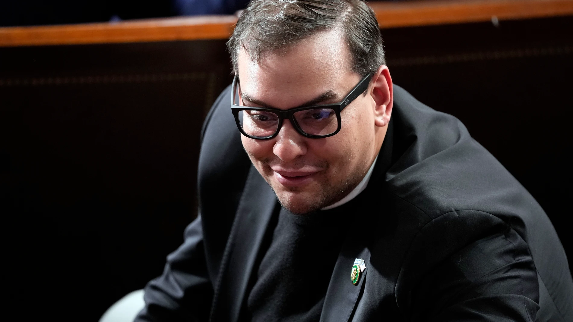FILE - Rep. George Santos, R-N.Y., watches as Republicans try to elect Rep. Mike Johnson, R-La., to be the new House speaker, at the Capitol in Washington, Wednesday, Oct. 25, 2023. A former fundraiser for U.S. Rep. Santos has pleaded guilty to a federal wire fraud charge. Sam Miele admitted Tuesday, Nov. 14, that he impersonated a high-ranking congressional aide while trying to rake in campaign cash for Santos, the embattled New York Republican. (AP Photo/Alex Brandon, File)