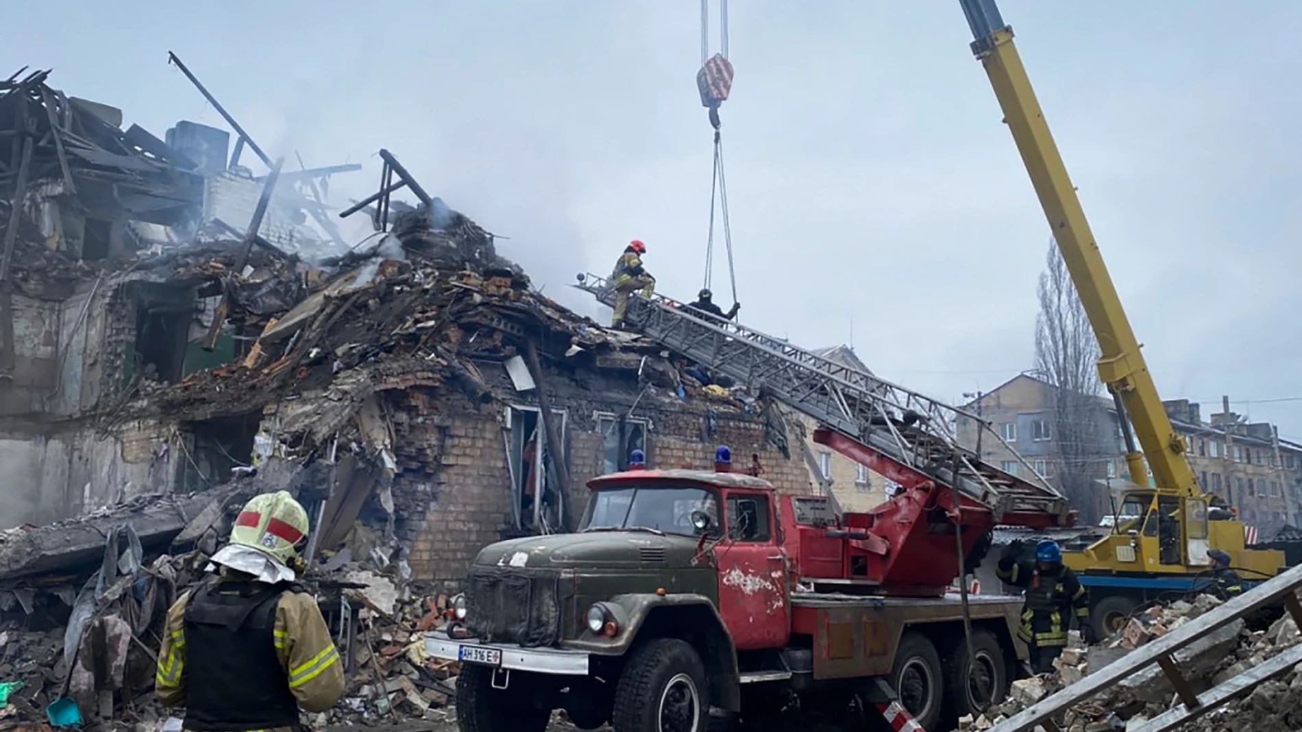 In this photo provided by the Ukrainian Emergency Service, rescuers work at the scene of a building damaged by shelling, in Novogrodivka, Ukraine, Thursday, Nov. 30, 2023. (Ukrainian Emergency Service via AP)
