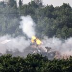 A picture taken from southern Israel near the border with the Gaza Strip on December 4, 2023, shows an Israeli tank firing at the Palestinian territory following amid continuing battles between Israel and the militant group Hamas.