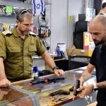 A customer listens to an employee's explanation as he selects handgun at a gun store in Jerusalem, Israel on October 26, 2023. In Israel, which has been attacked by Hamas, the number of civilian buying guns for self-defense is rapidly increasing.( The Yomiuri Shimbun ) (Photo by Mochinari Nishida / Yomiuri / The Yomiuri Shimbun via AFP)