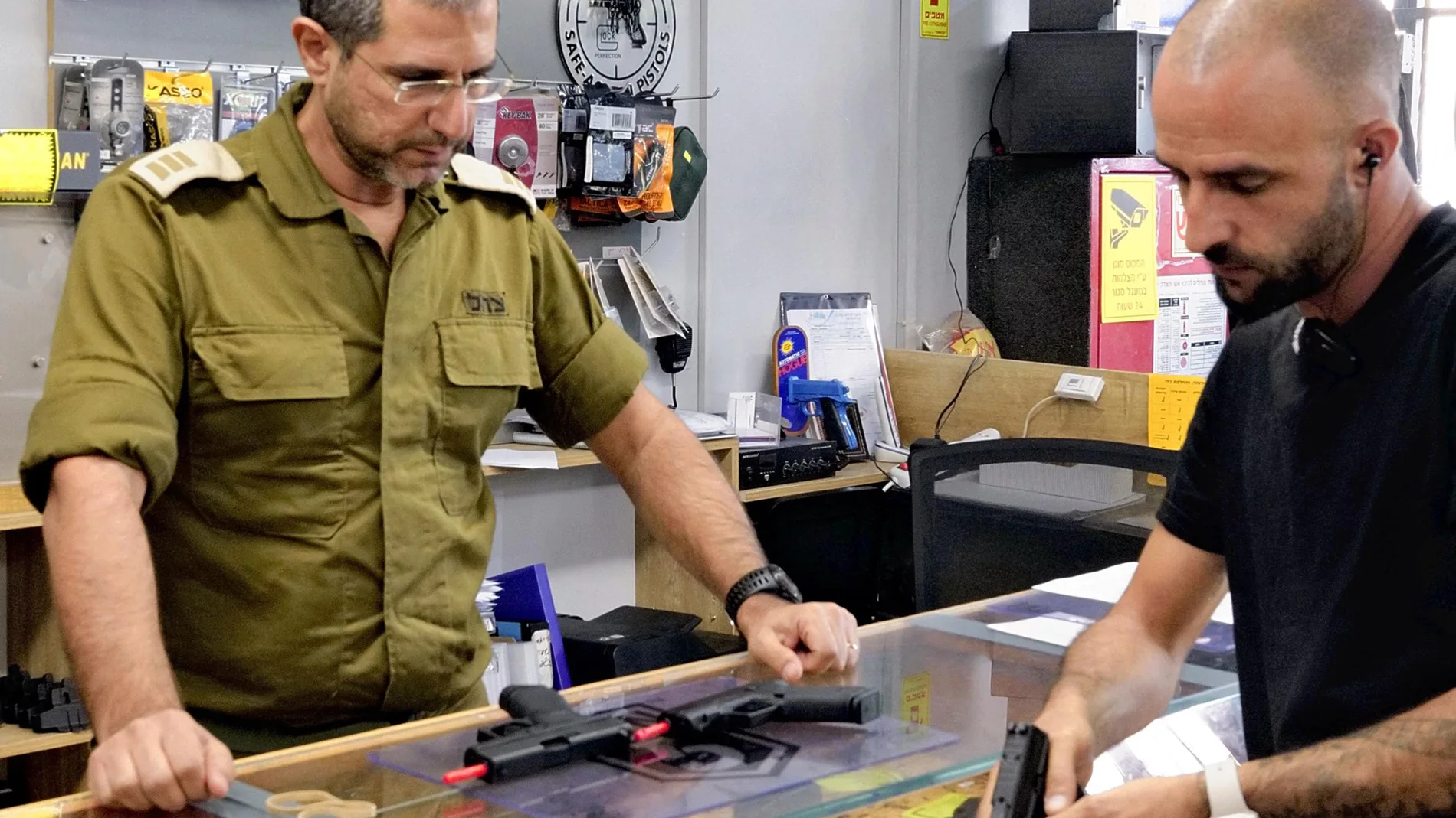A customer listens to an employee's explanation as he selects handgun at a gun store in Jerusalem, Israel on October 26, 2023. In Israel, which has been attacked by Hamas, the number of civilian buying guns for self-defense is rapidly increasing.( The Yomiuri Shimbun ) (Photo by Mochinari Nishida / Yomiuri / The Yomiuri Shimbun via AFP)