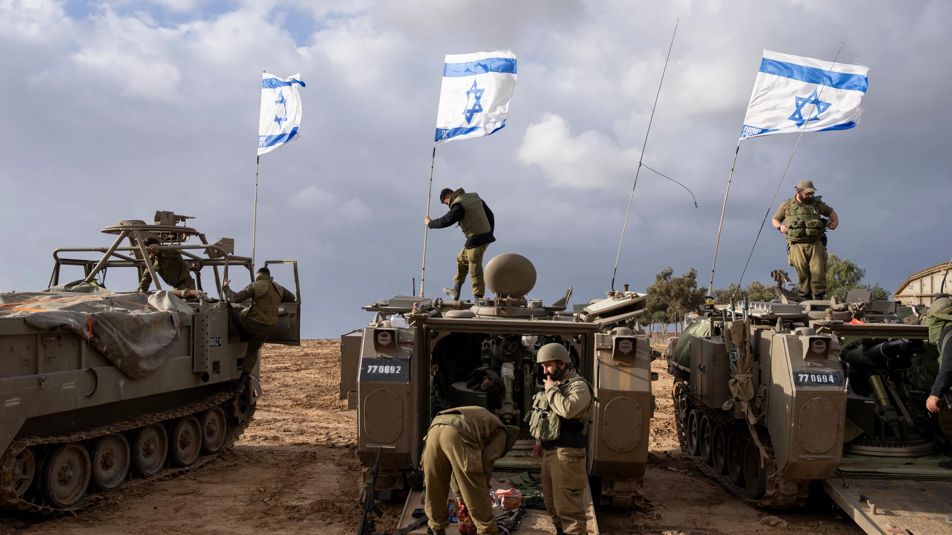 FILE - Israeli soldiers work on armored military vehicles along Israel's border with the Gaza Strip, in southern Israel, on Monday, Nov. 20, 2023. The Israeli military has rounded up hundreds of Palestinians across the northern Gaza Strip, separating families and forcing men to strip to their underwear before trucking some to an undisclosed location. The roundups have laid bare an emerging tactic in Israel's ground offensive in Gaza, experts say, as the military seeks to solidify control in e...