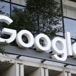 A Google sign hangs over an entrance to the company's new building, in New York.
