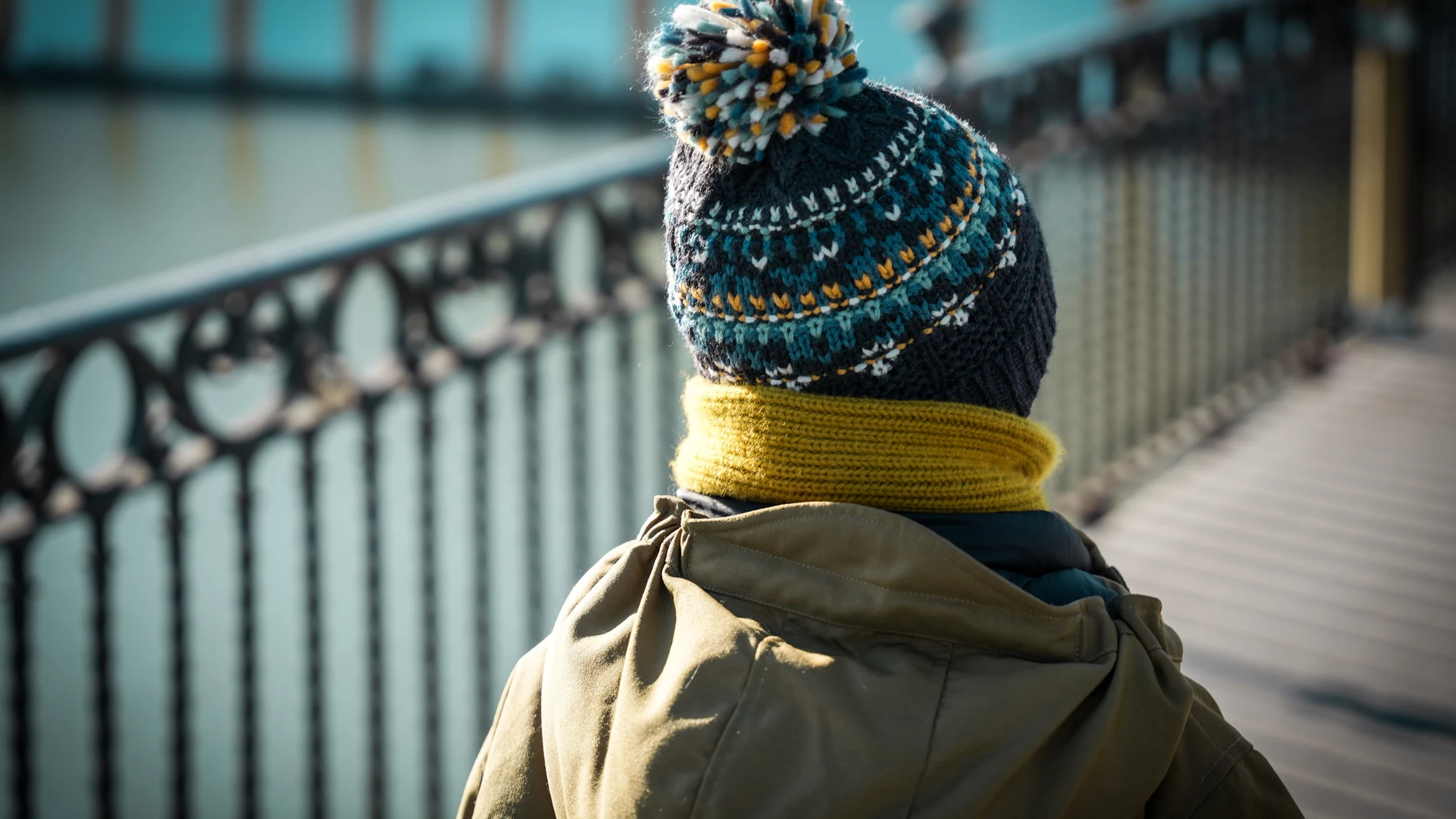 Un niño abrigado con gorro y bufanda