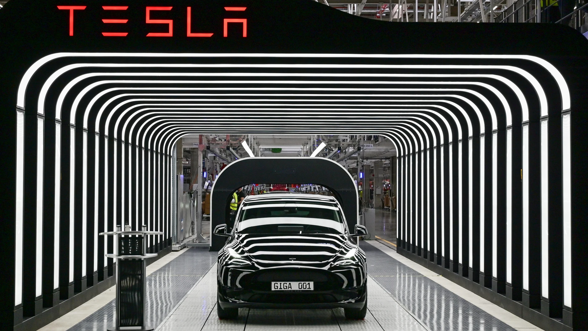 FILE - Model Y electric vehicles stand on a conveyor belt at the opening of the Tesla factory in Berlin Brandenburg in Gruenheide, Germany, Tuesday, March 22, 2022. Tesla production stands still because of The armed conflicts in the Red Sea and the associated shifts in transport routes between Europe and Asia. (Patrick Pleul/Pool via AP, File)