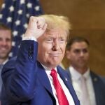 Eric Trump, left, smiles as Former President Donald Trump thanks supporters who were cheering him on after a news conference, Thursday, Jan. 11, 2024, in New York.