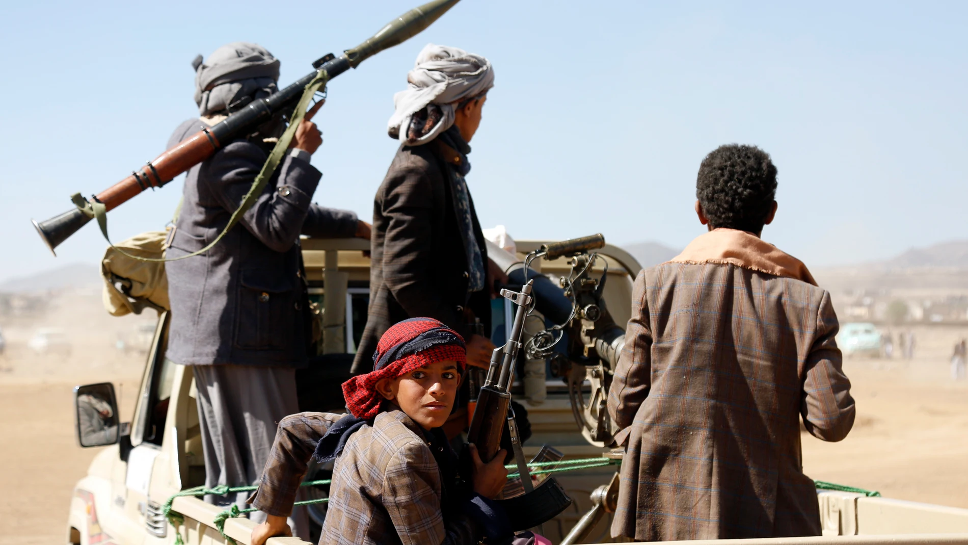 Houthi fighters and tribesmen stage a rally against the U.S. and the U.K. strikes on Houthi-run military sites near Sanaa, Yemen, on Sunday, Jan. 14, 2024. (AP Photo)