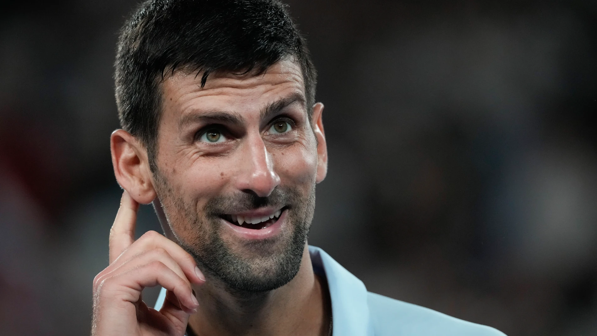 Serbia's Novak Djokovic reacts during his first round match against Croatia's Dino Prizmic at the Australian Open tennis championships at Melbourne Park, Melbourne, Australia, Sunday, Jan. 14, 2024. (AP Photo/Alessandra Tarantino)