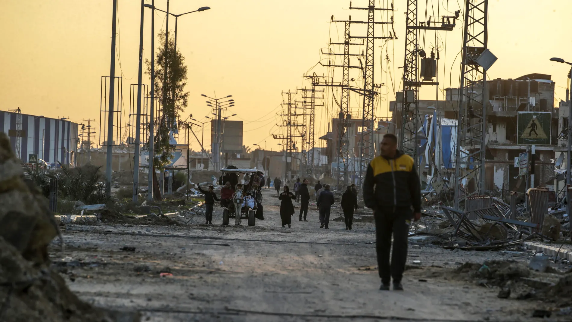Al Bureije Refugee Camps (---), 24/01/2024.- Palestinians walk a long Salah Al Al Din road during an Israeli military operation in Al Bureij refugee camp in the southern Gaza Strip, 24 January 2024. More than 25,600 Palestinians and at least 1,330 Israelis have been killed, according to the Palestinian Health Ministry and the Israel Defense Forces (IDF), since Hamas militants launched an attack against Israel from the Gaza Strip on 07 October 2023, and the Israeli operations in Gaza and the W...