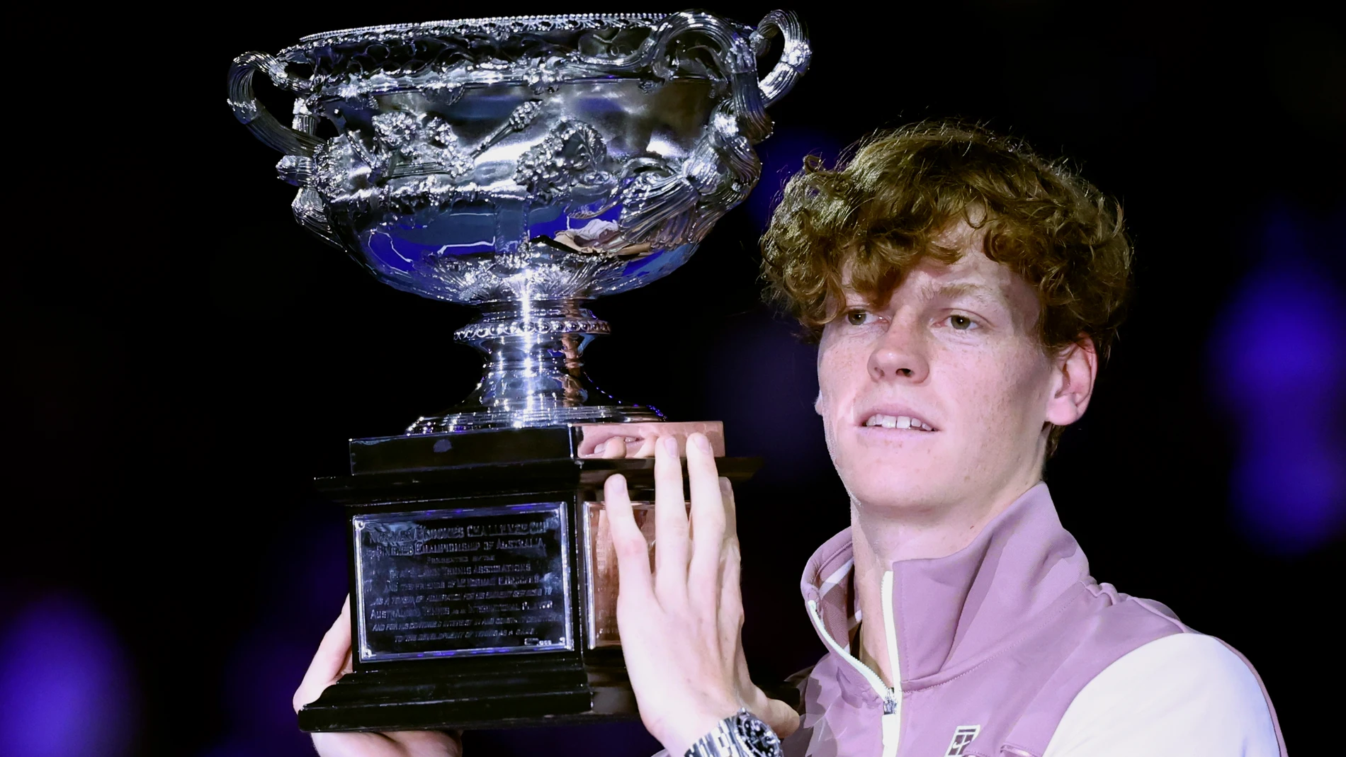 Jannik Sinner of Italy holds the Norman Brookes Challenge Cup aloft after defeating Daniil Medvedev of Russia in the men's singles final at the Australian Open tennis championships at Melbourne Park, in Melbourne, Australia, Sunday, Jan. 28, 2024. (AP Photo/Asanka Brendon Ratnayake)