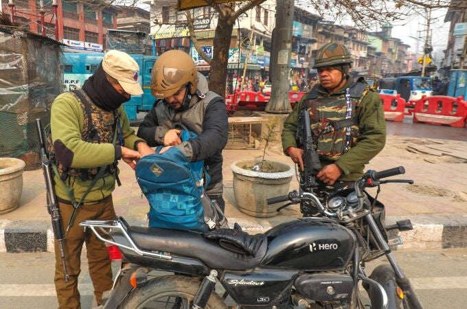  An Indian police officer checks the bag of a man during a surprise search operation in Srinagar, the summer capital of Indian Kashmir.