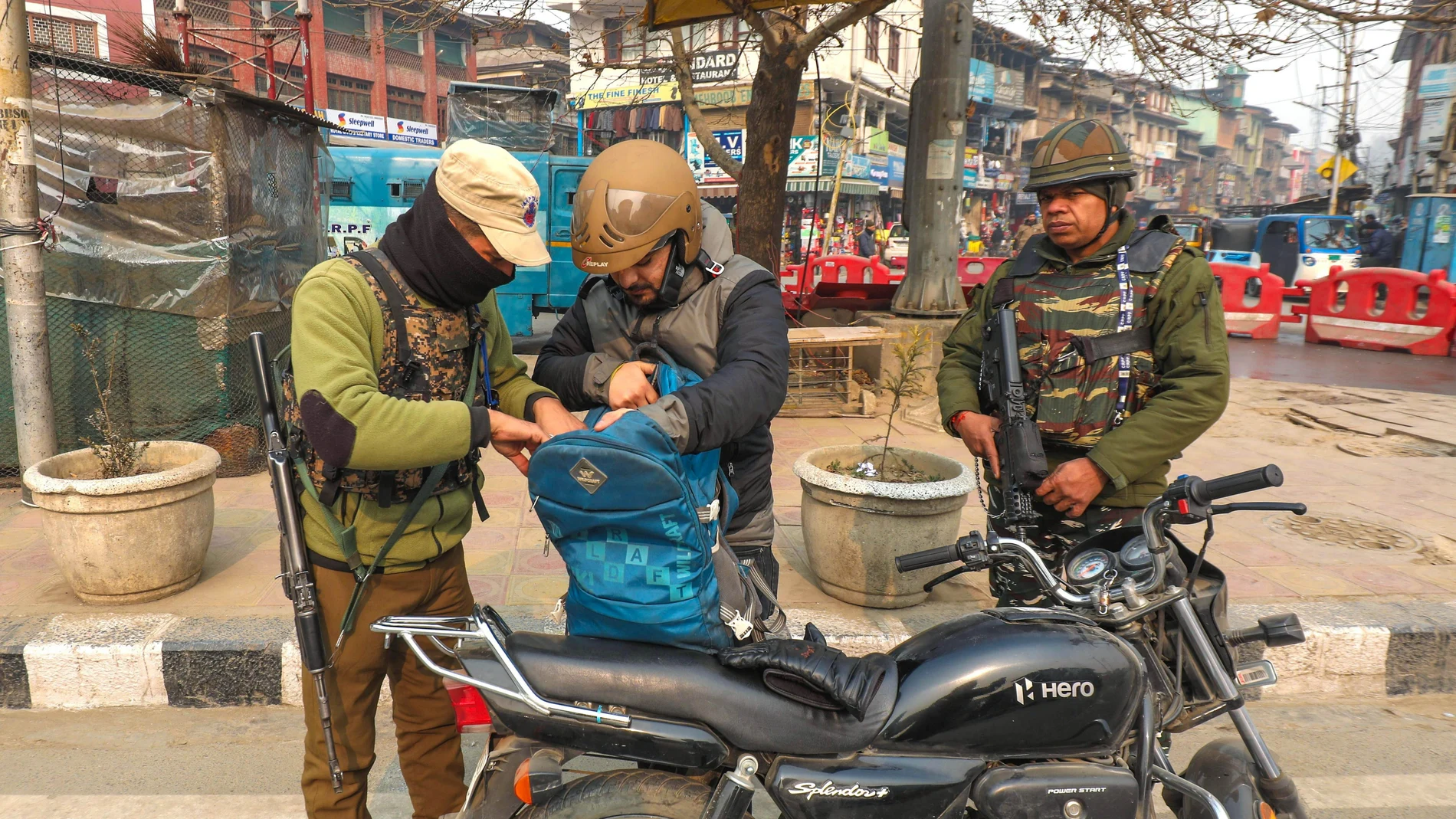 An Indian police officer checks the bag of a man during a surprise search operation in Srinagar, the summer capital of Indian Kashmir.