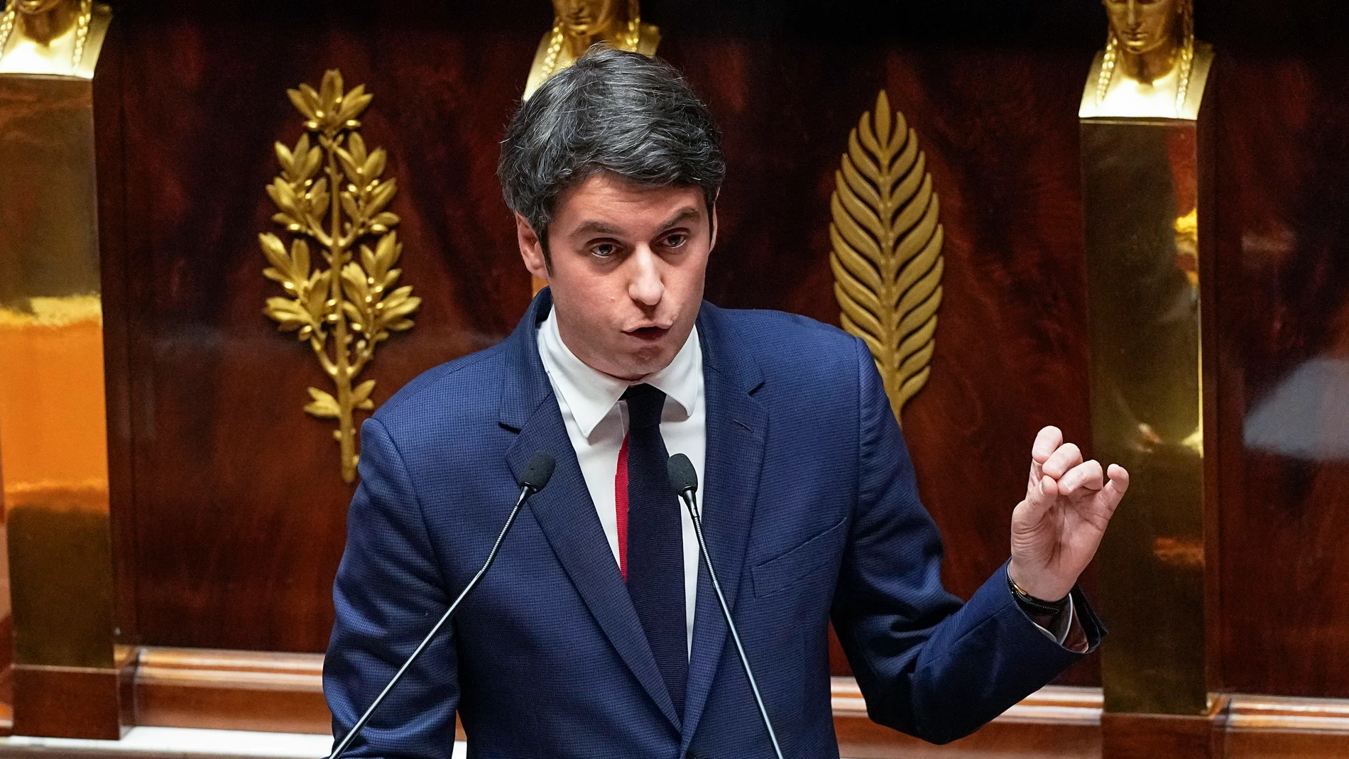 French Prime Minister Gabriel Attal gestures as he speaks to the lawmakers at the National Assembly, Tuesday, Jan. 30, 2024 in Paris. French Prime Minister Gabriel Attal said on Tuesday his top priority is to boost employment in his general policy address to lawmakers, three weeks after he was appointed. Attal is facing his first major challenge as angry farmers are protesting across the country and around Paris against low wages and other problems.(AP Photo/Michel Euler)