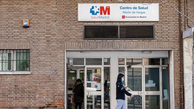 Una mujer con mascarilla en la puerta del centro de salud Martín de Vargas