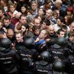 Agentes antidisturbios de la Policía Nacional forman un cordón de seguridad en los alrededores del colegio Ramón Llull de Barcelona el 1-O