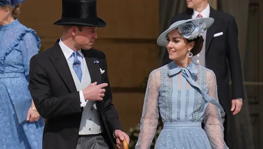 William, Prince of Wales, speaks with his wife Kate, Princess of Wales, during a Garden Party at Buckingham Palace, in celebration of the coronation.